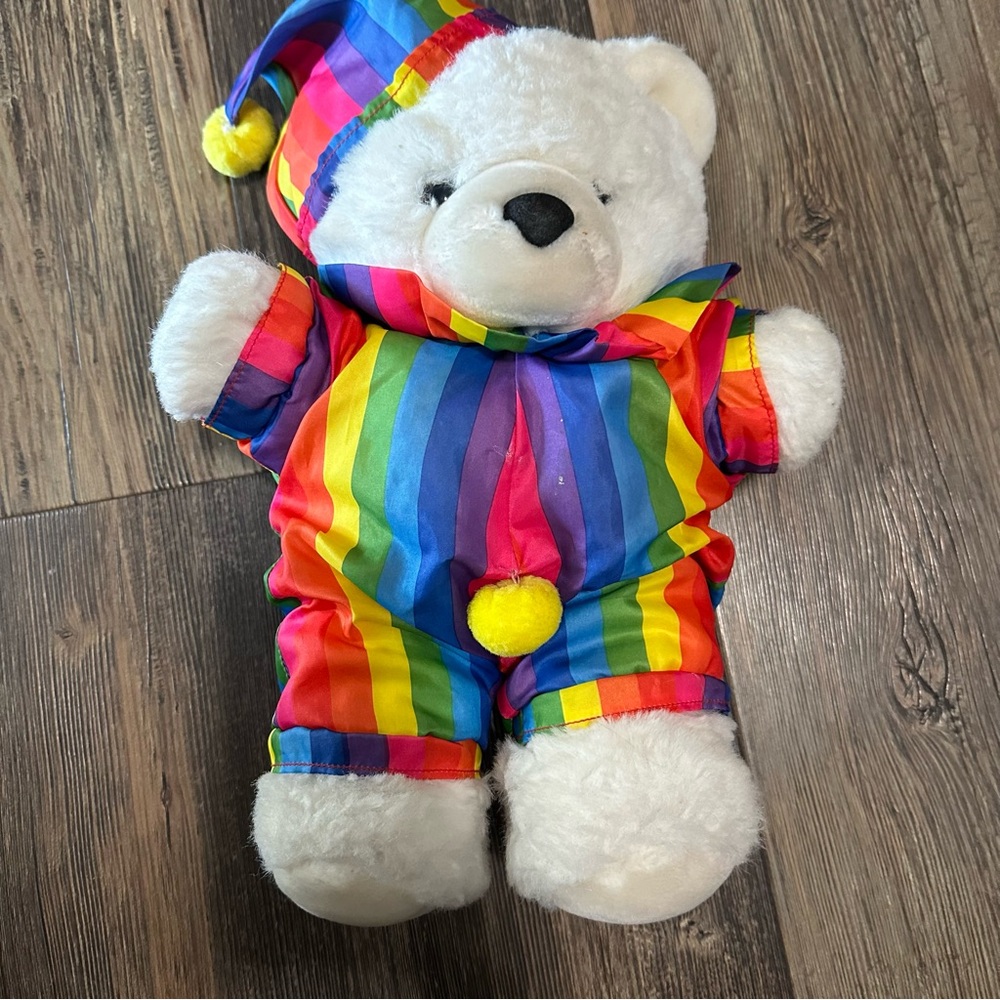 Vintage white teddy bear with rainbow clown outfit